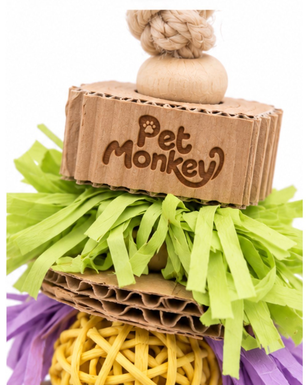 Pet Monkey hanging paper shredder bird toy, close-up of the Pet Monkey logo embossed into the cardboard piece